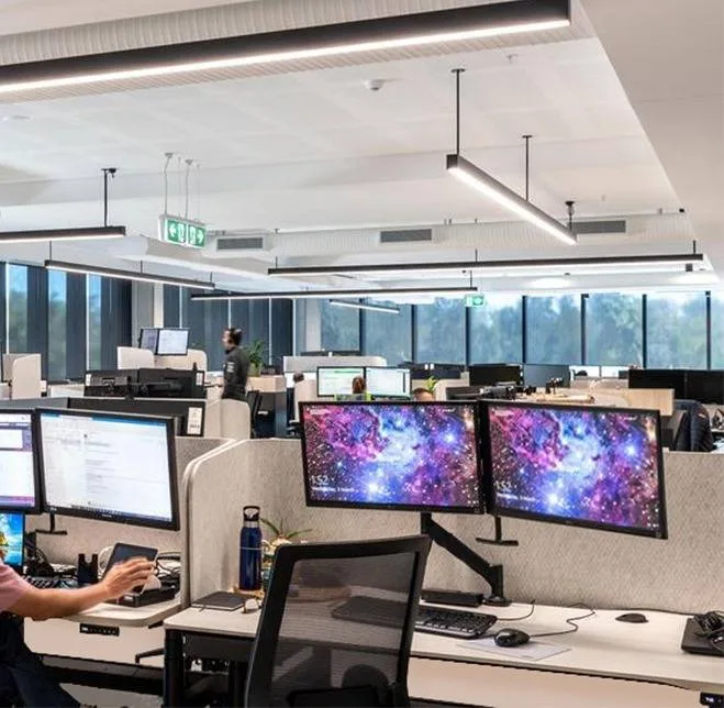 Sit-to-stand workstations with dual monitors on Atdec arms at Dicker Data's Sydney headquarters