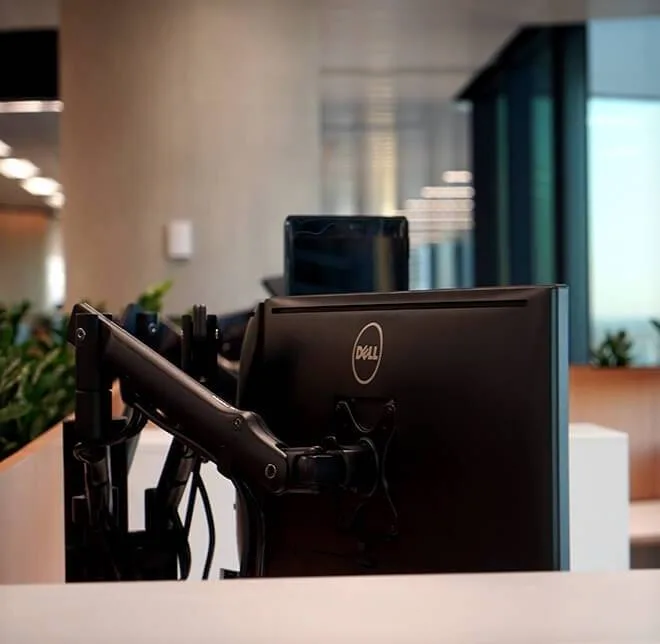 Open-plan workstations with monitor arms in Gilbert + Tobin's Barangaroo office