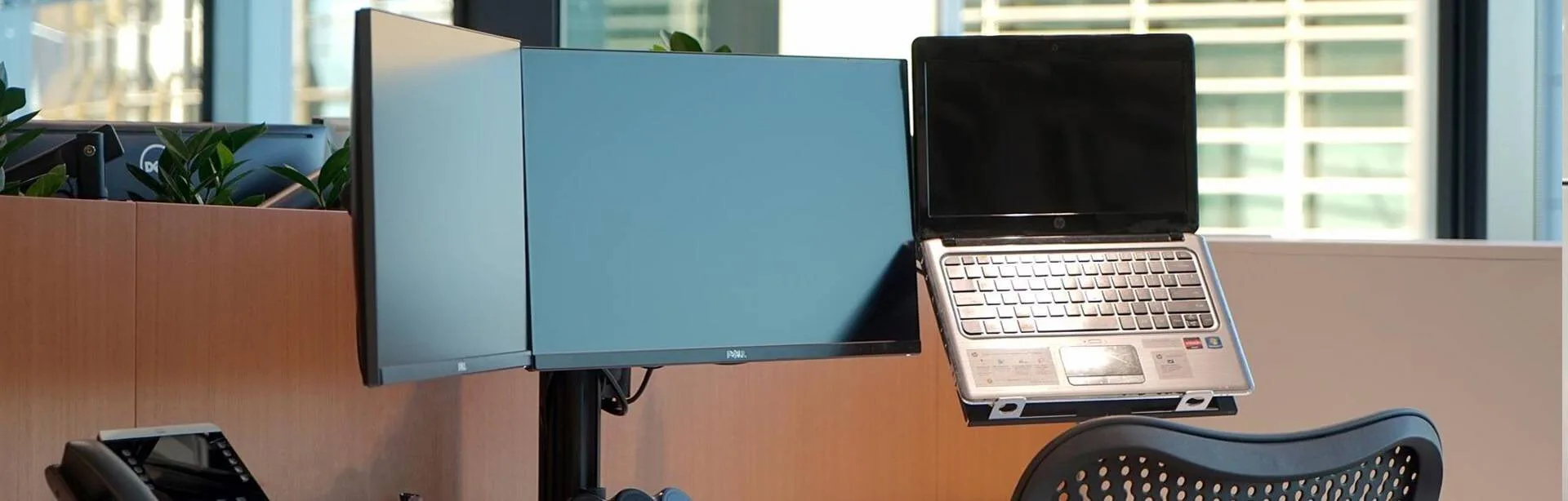 Open-plan workstations with monitor arms at Gilbert + Tobin in Sydney
