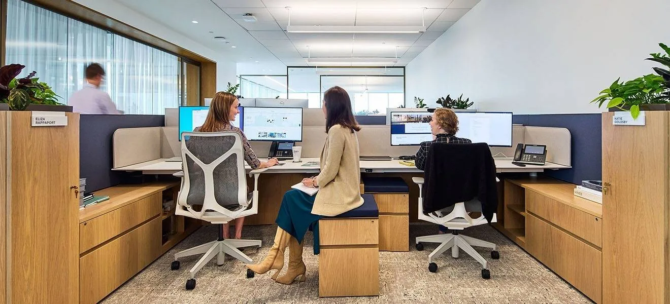 Atdec AWMS-2-D13 dual monitor arms on benching desks at Hines' Houston headquarters