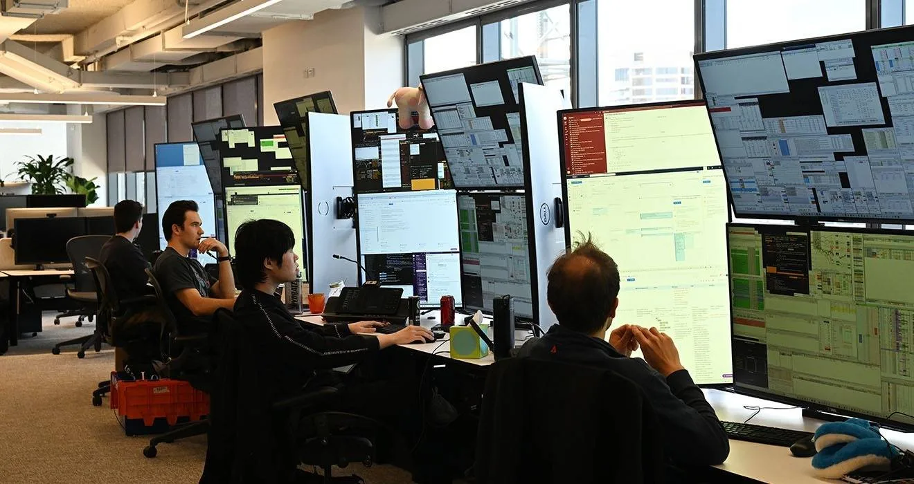 Rows of multi-monitor desks on Optiver's Sydney trading floor