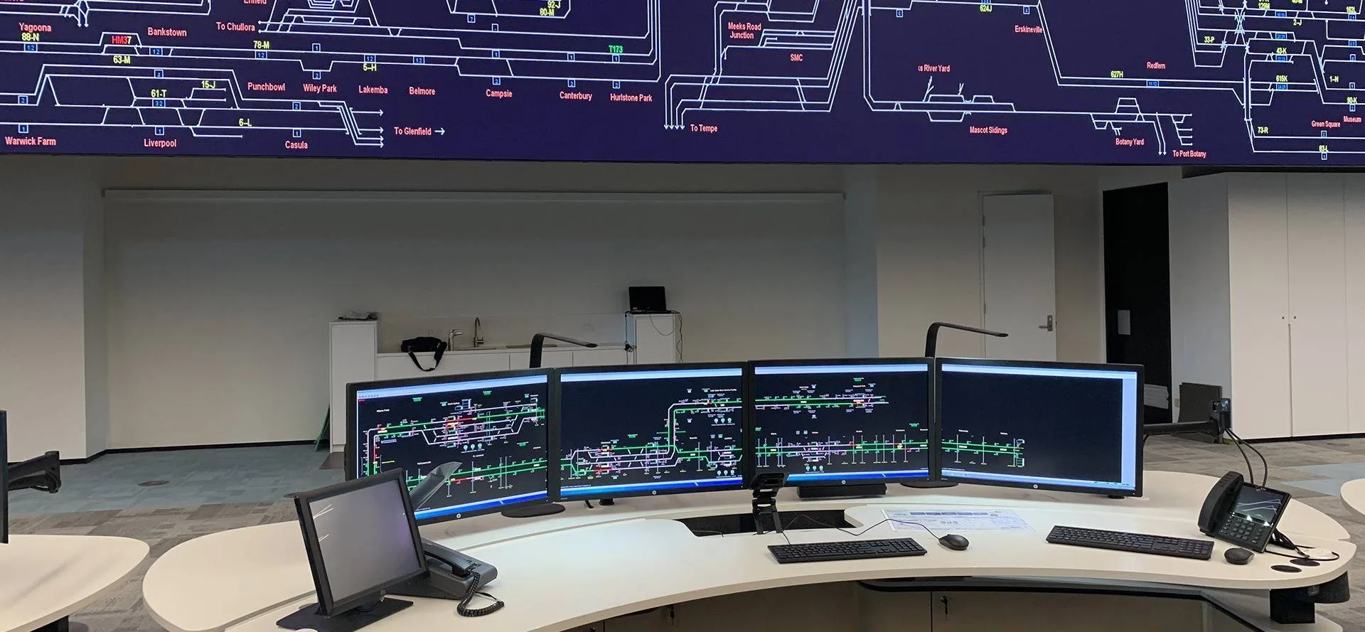 Sydney Trains Rail Operations Centre with multi-screen workstations on Atdec mounts